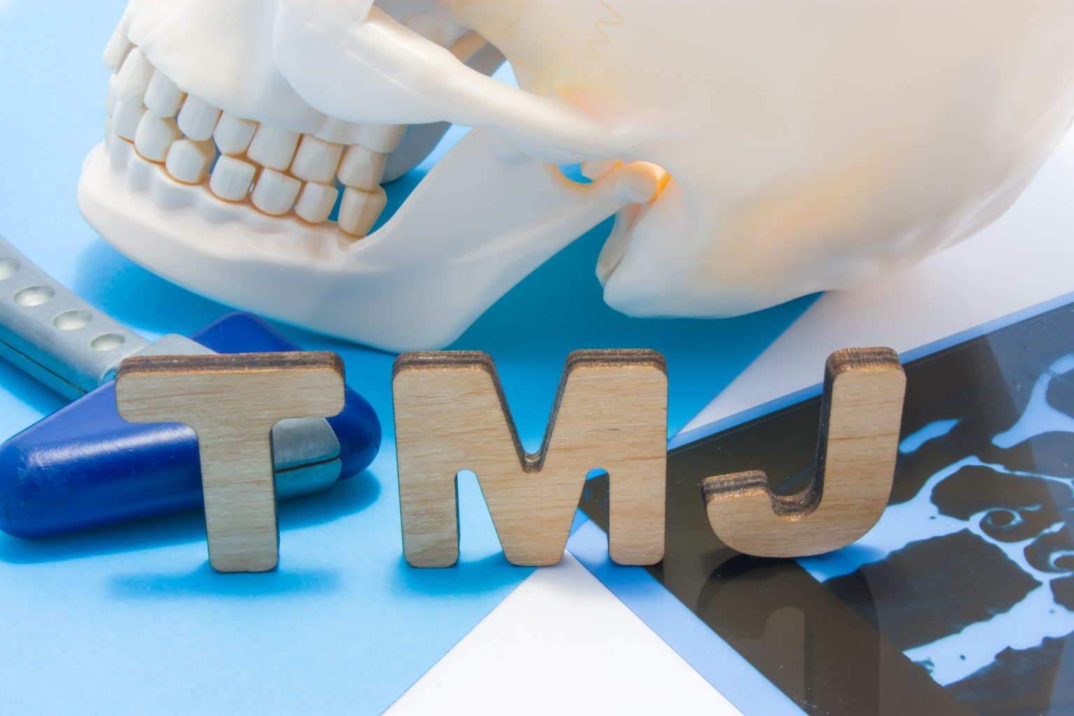 Tmj Medical Abbreviation Of Temporomandibular Joint. Tmj Letters Surrounded By Human Skull With Lower Jaw, Neurological Hammer And Radiographs. Concept Of Anatomy, Pathology Of Temporomandibular Joint